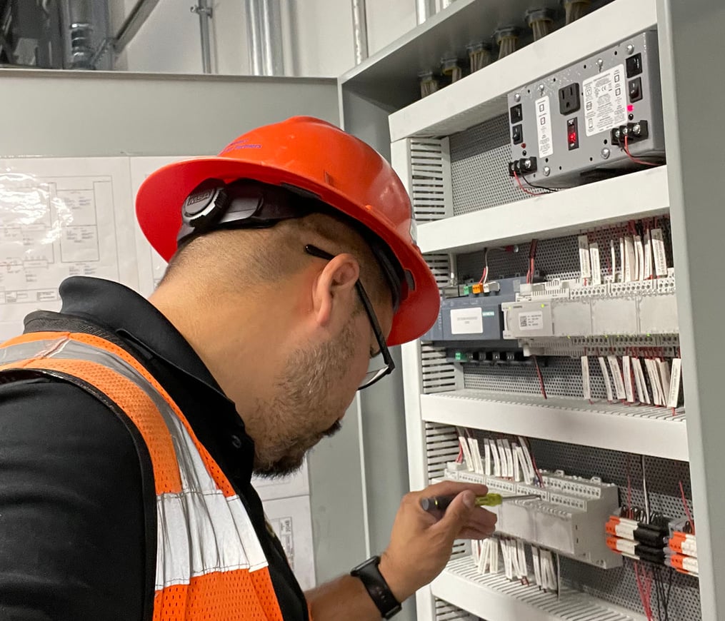 Controls and Building Automation project manager wearing orange hard hat and safety vest