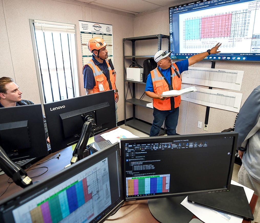 Project managers review plans in a TDIndustries job site trailer during a data center project