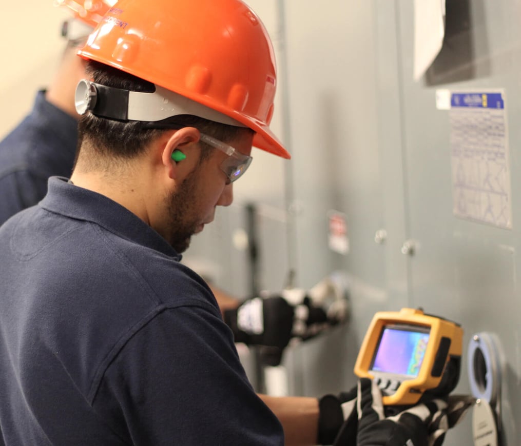 TDIndustries electricians check customer equipment with infrared scanner