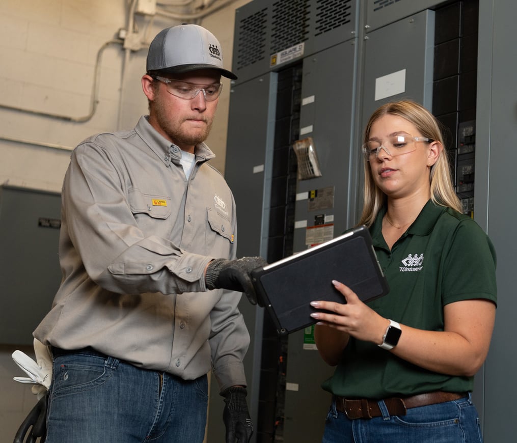 TD commercial electrician reviews safety protocol with EHS manager